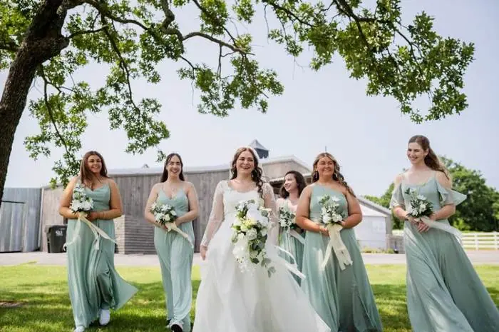 Bridal party sage green dresses outdoor Oklahoma wedding venue under oak tree