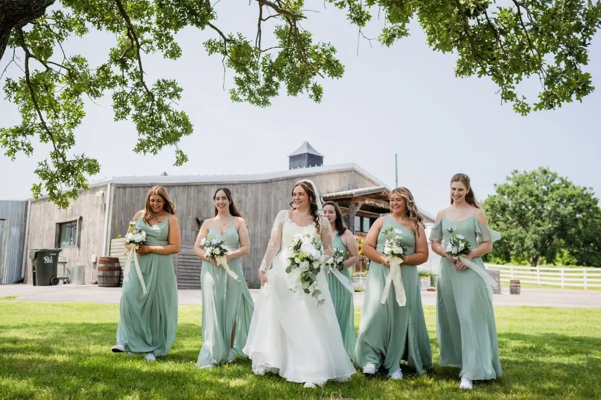 Bridal party sage green dresses outdoor Oklahoma wedding venue bride bridesmaids