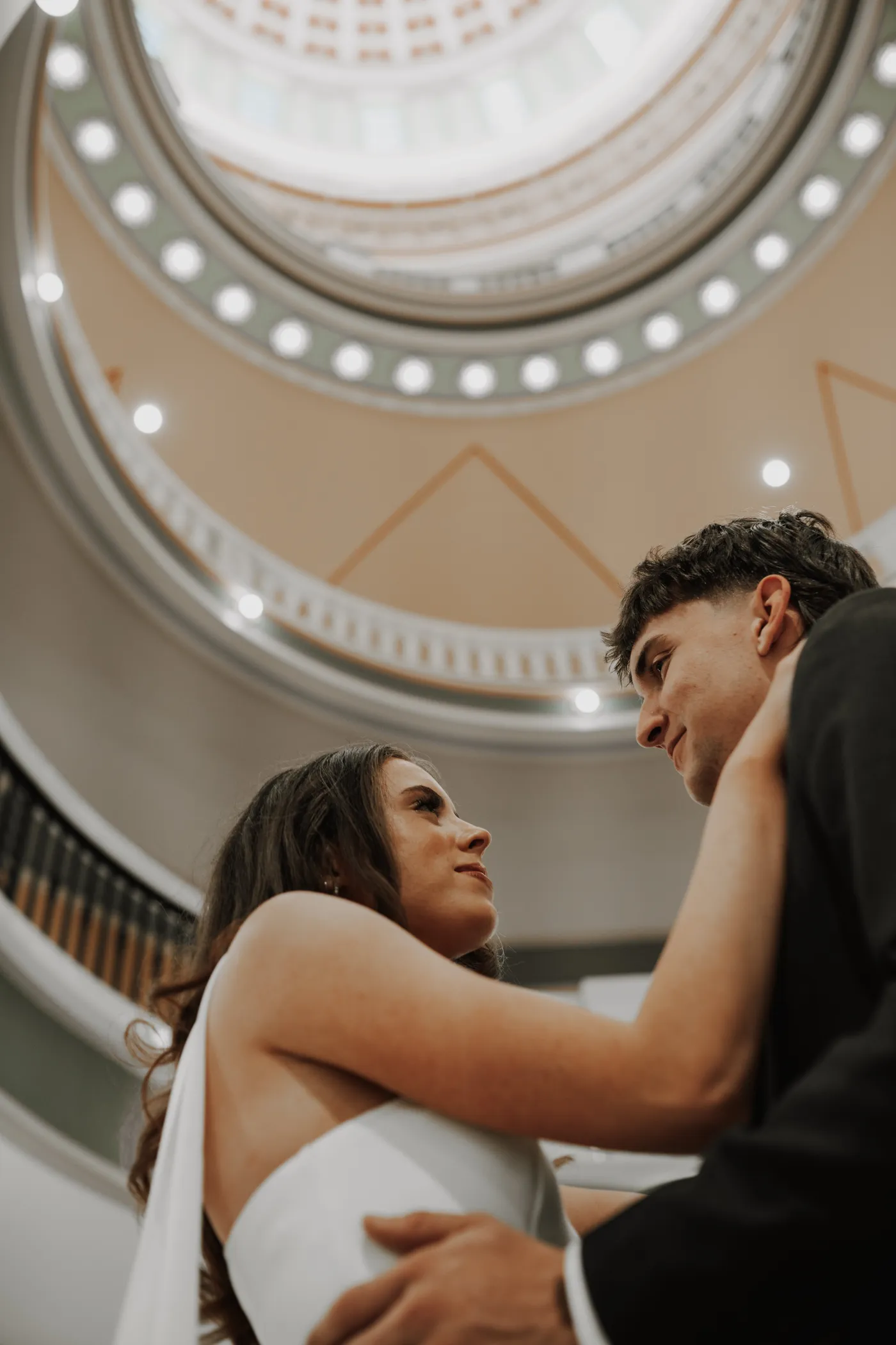 Bride and groom under rotunda dome elegant Oklahoma wedding photography