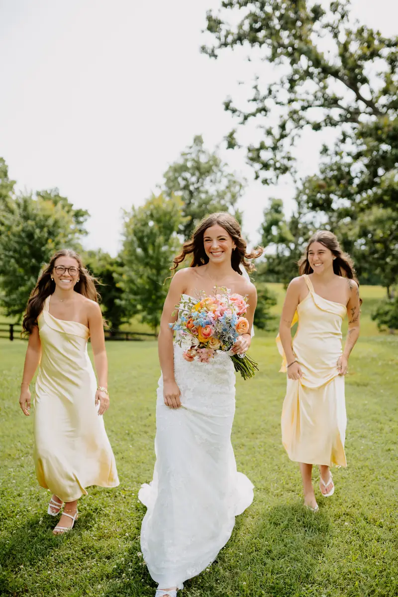 Bride walking with bridesmaids in yellow dresses Oklahoma wedding photography