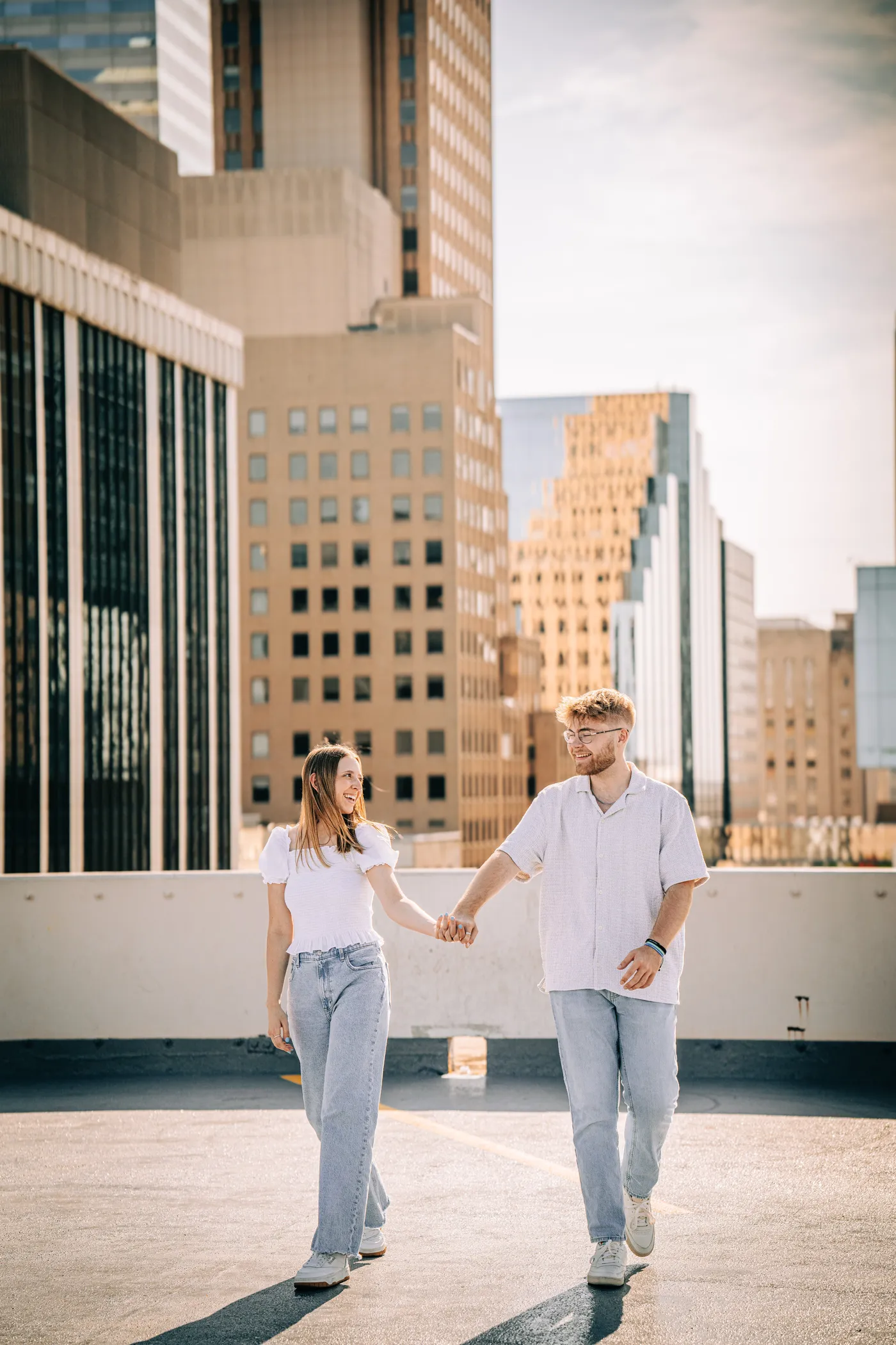 Couple holding hands rooftop downtown Oklahoma City engagement photography