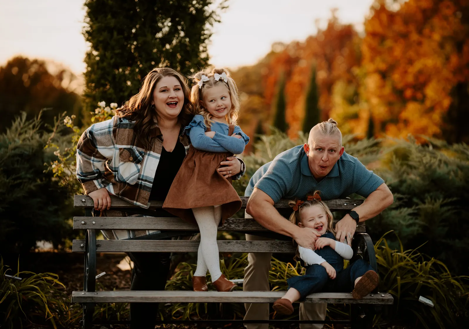Family of four on park bench autumn colors fall mini sessions Oklahoma