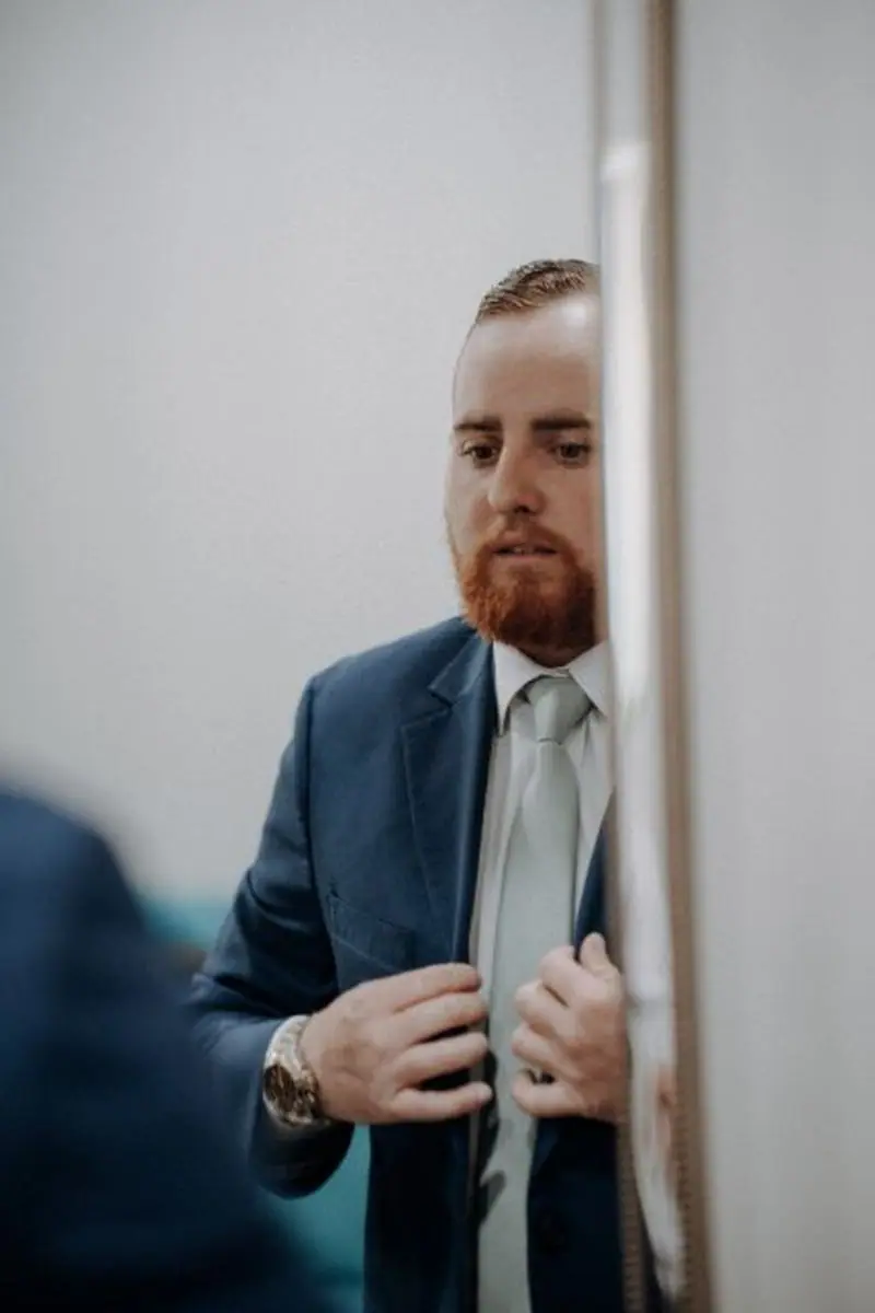 Groom getting ready mirror reflection blue suit wedding day Oklahoma photographer