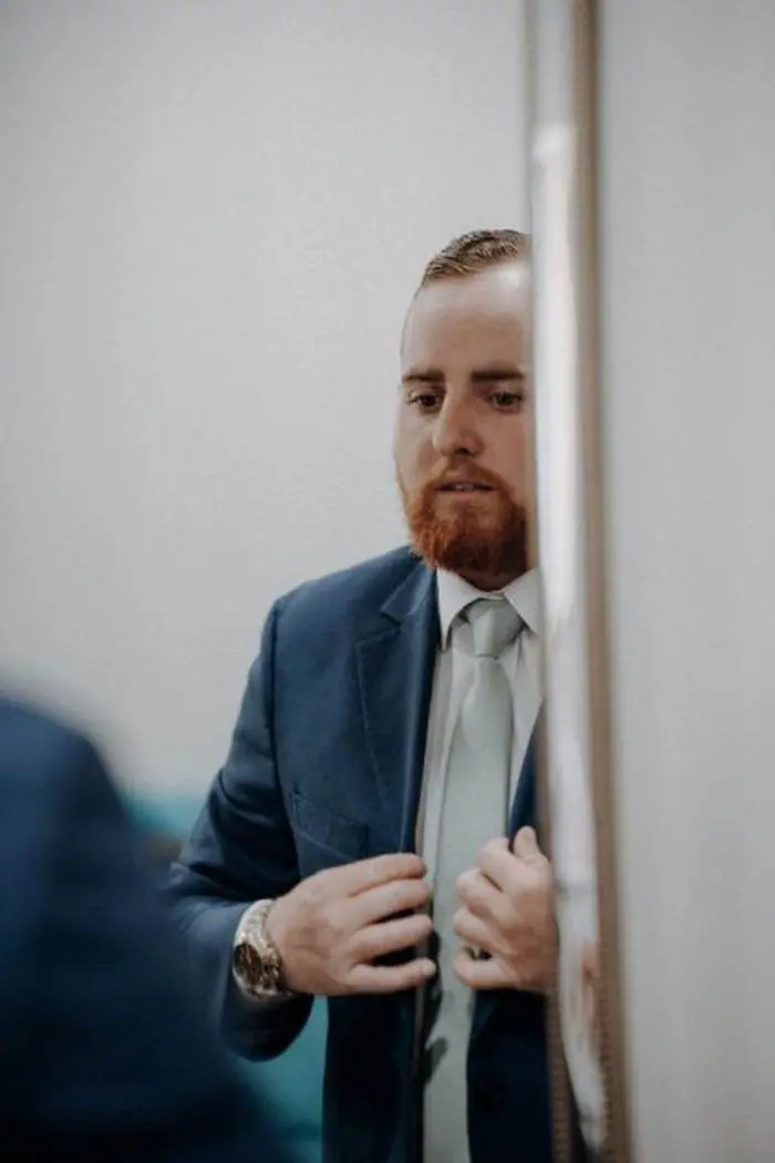Groom getting ready mirror reflection blue suit wedding day Oklahoma photographer