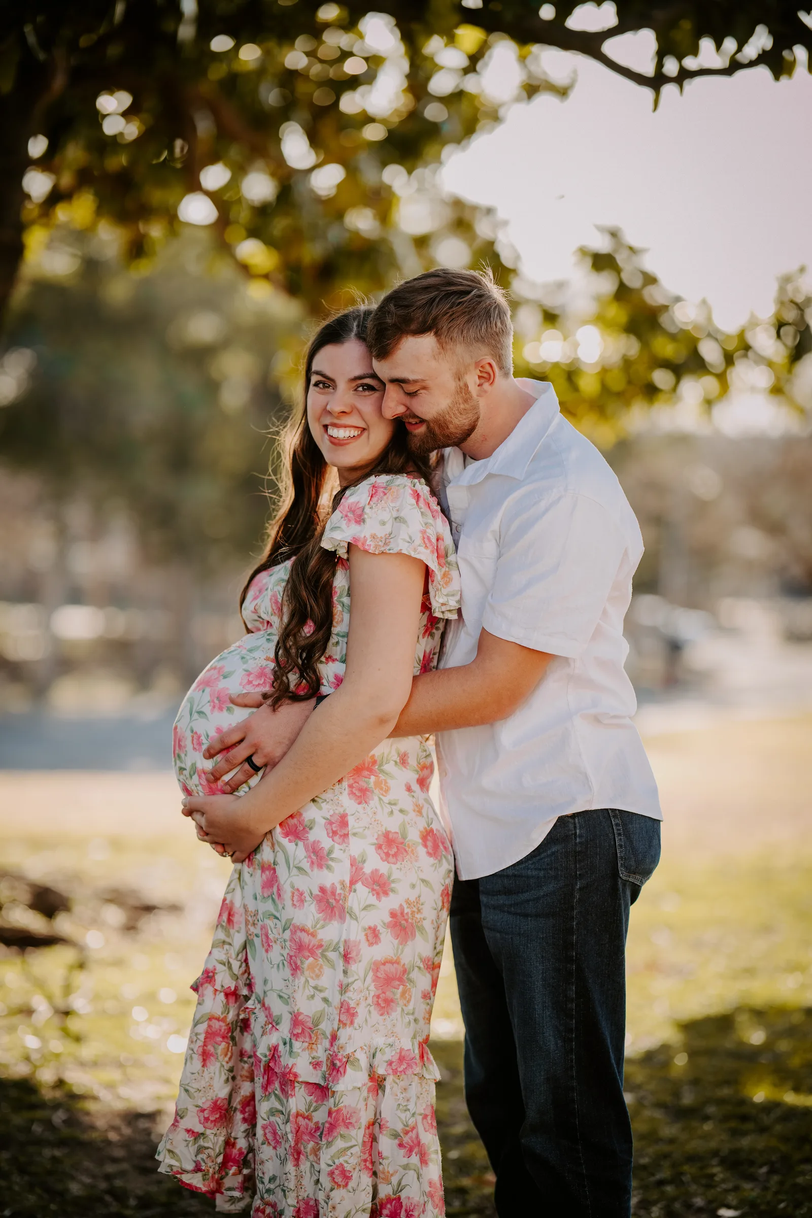 Maternity couple holding hands by window black and white Oklahoma