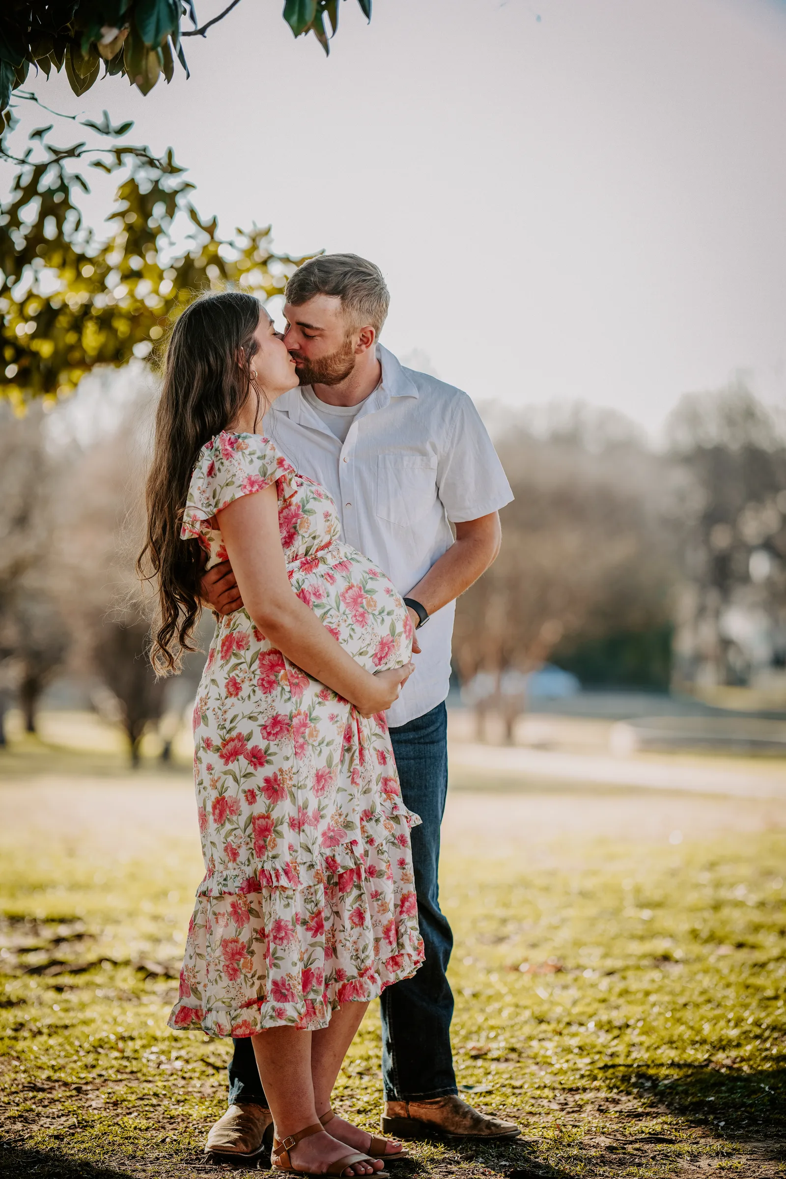 Maternity couple kiss floral dress park Oklahoma