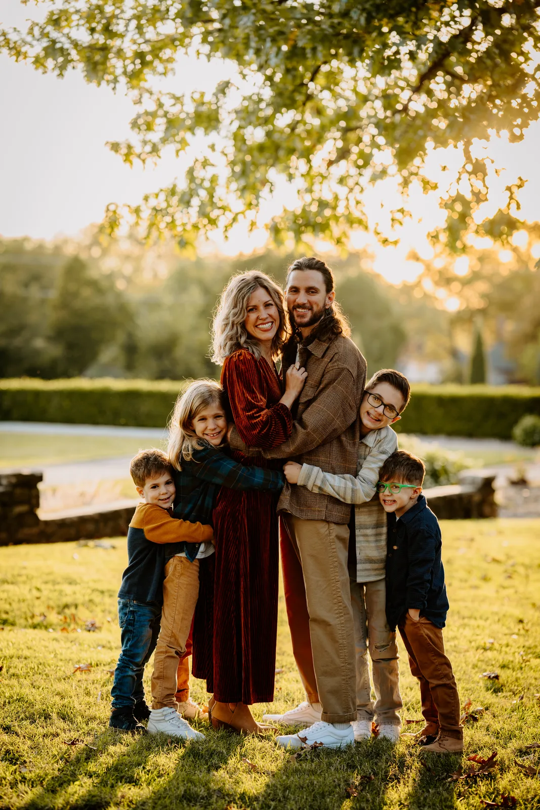 Parents hugging three kids golden hour park family photos Oklahoma