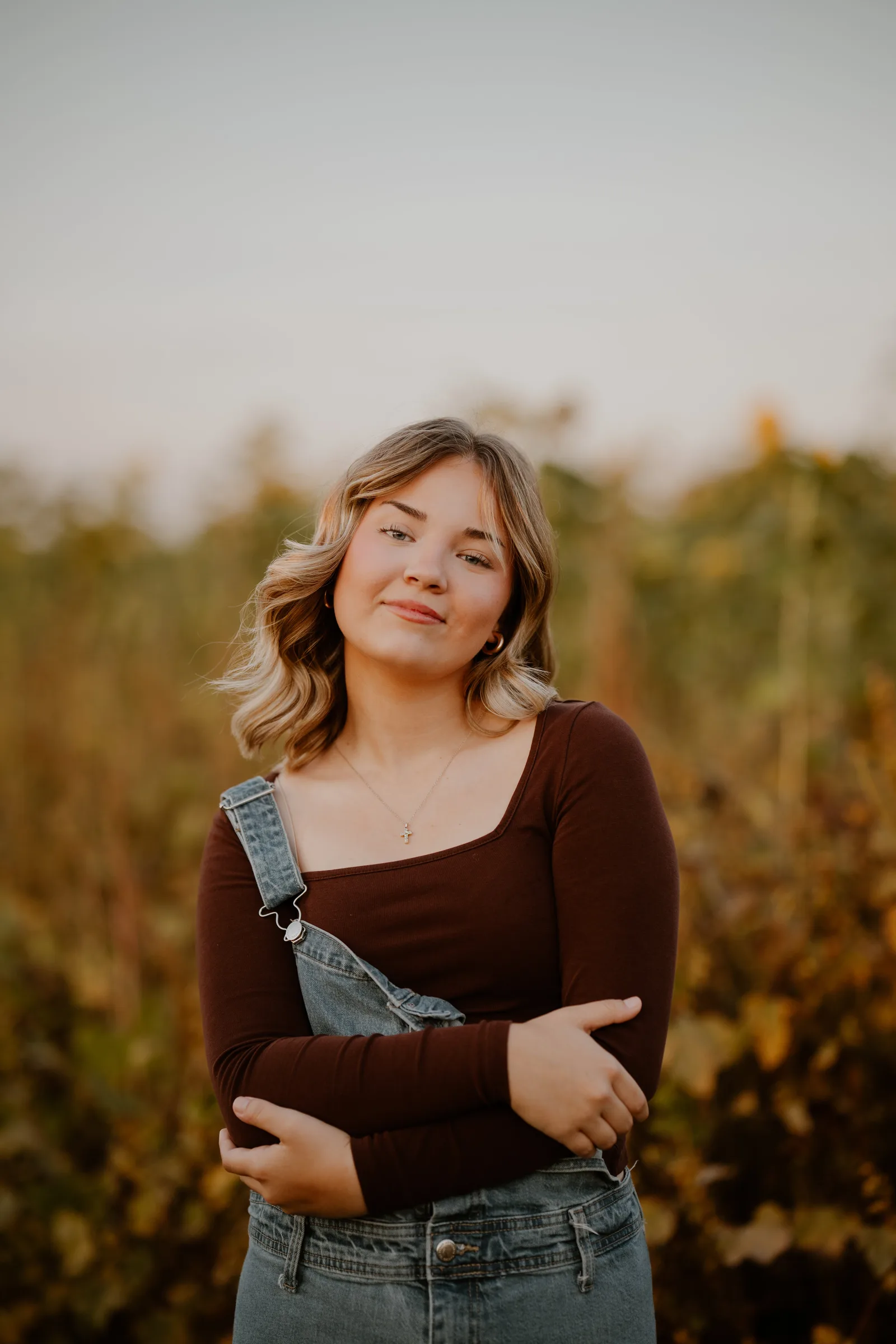 Girl in overalls golden field portrait session Oklahoma