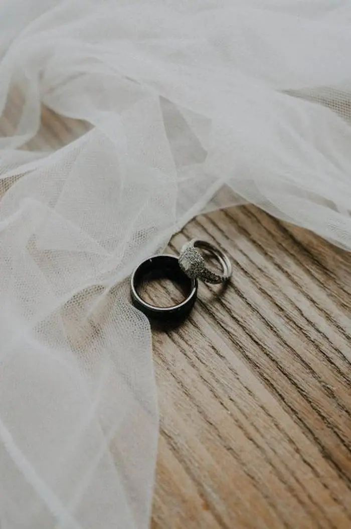 Wedding rings on wood with veil detail photography Oklahoma